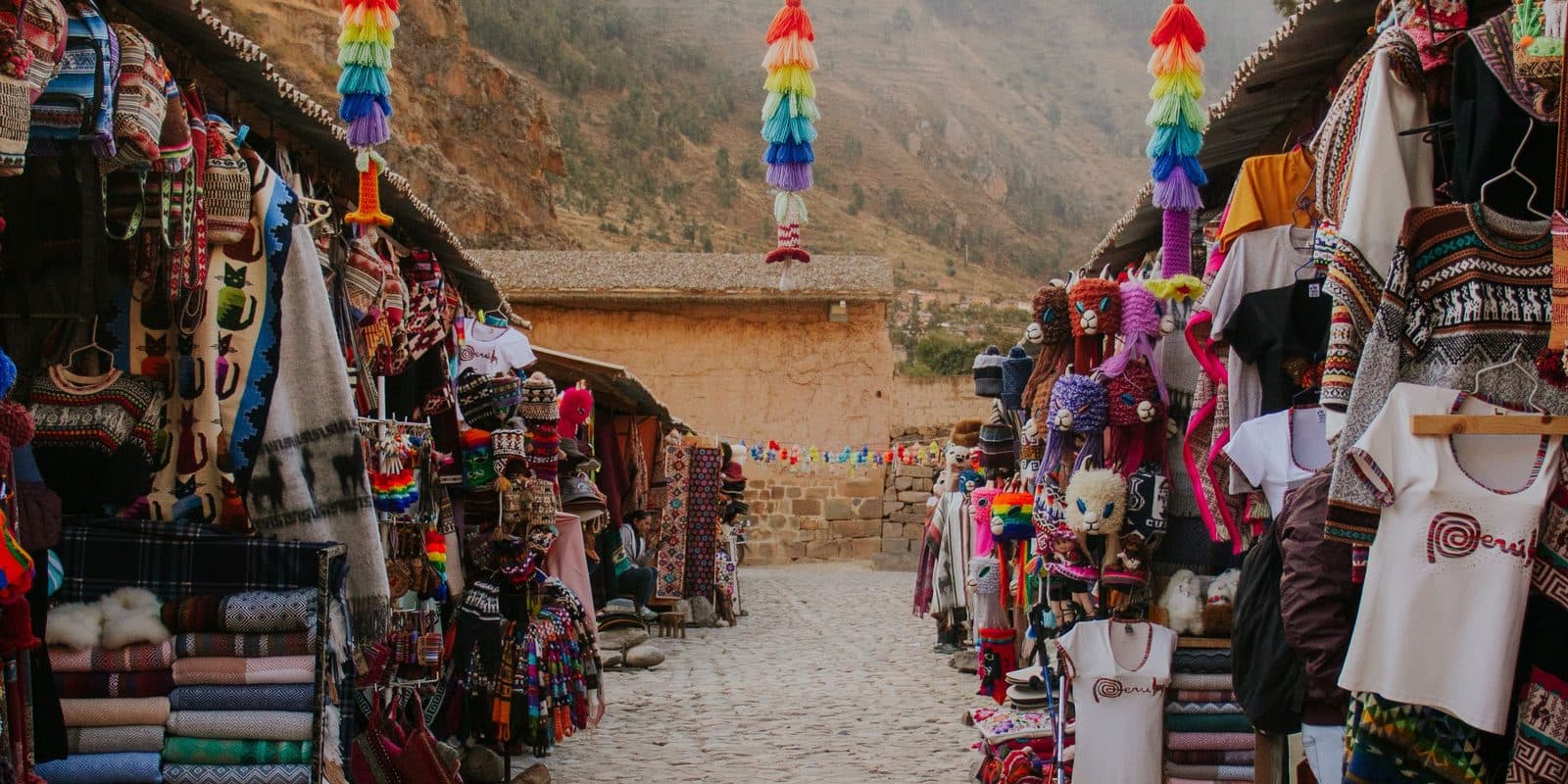Market stalls in Ollantaytambo with weavings and produce, Sacred Valley of Peru